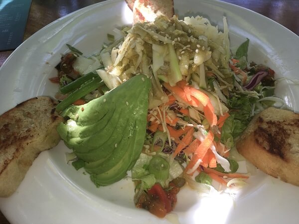 Lola's Asian Green Papaya salad with avocado, salsa and toasted bread.