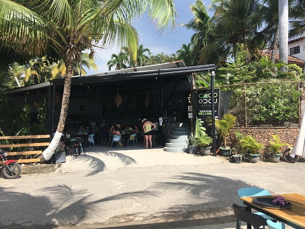 The protected indoor dining area is across the street from the tables on the beach.