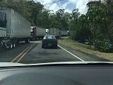 Trucks line up in the opposite lane on Costa Rica's highway 1