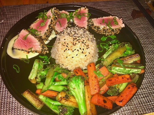 Perfectly prepared medium rare sushi, stir fry vegetables and rice with a curry mayonnaise sauce.