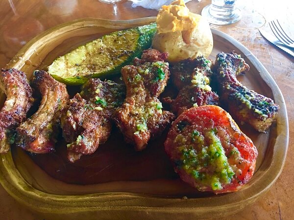 El Lagarto ribs, baked potato and grilled tomato and zucchini.