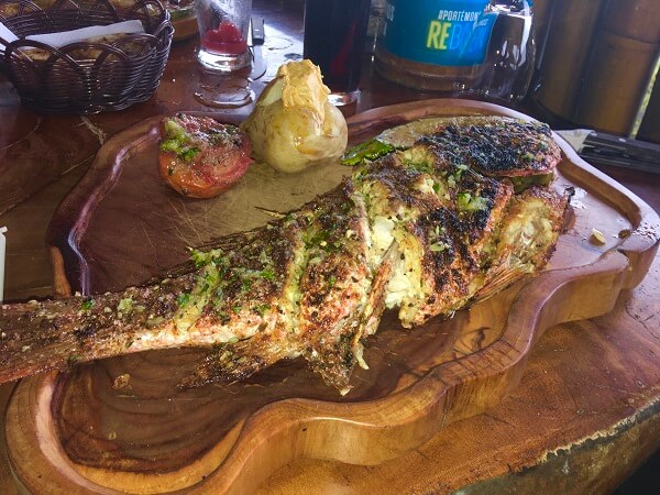 El Lagarto whole red snapper with grilled tomato and baked potato.