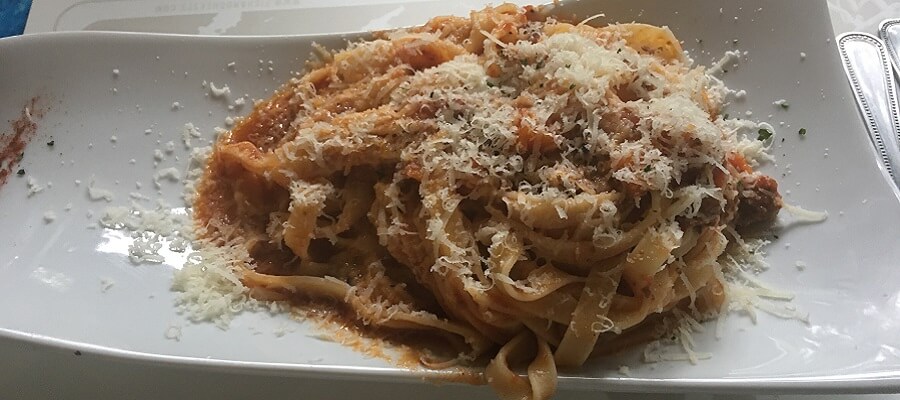 Fresh homemade pasta and tomato sauce with a nice fresh, aged parmesan cheese.