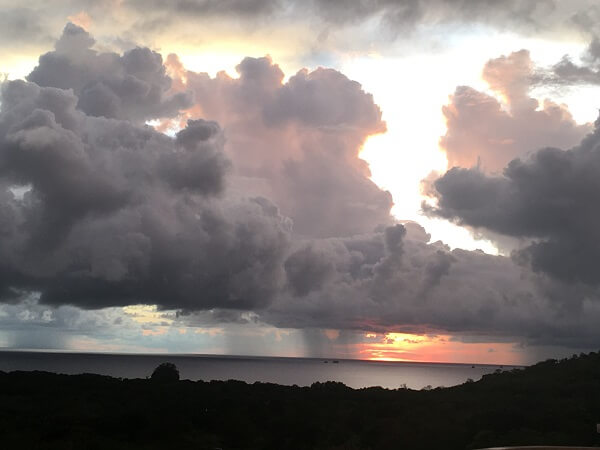 Sun sets during a Costa Rica thunderstorm in rainy season.