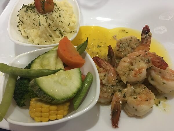 Jumbo shrimp in a butter and garlic sauce along with pureed butter potatoes and steamed vegetables.