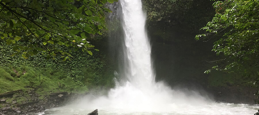 View of the lower pool at La Fortuna falls as water crashes down from 200 feet above.