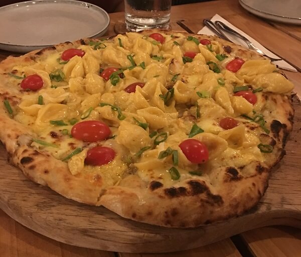 Mac and Cheese, tomatoes, basil and a lobster sauce make this pizza absolutely delicious.