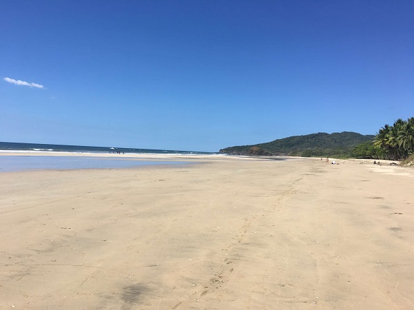 Playa Grande looking north with few people and lots of gentle sloping sand.