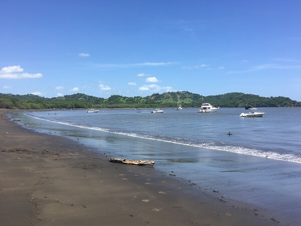 Boats in the harbor with calm water at Playa Panama Costa Rica.