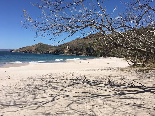 View of the sand and surf looking north from Playa Zapotillal.