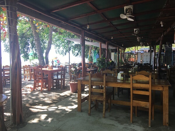 Dining area under the trees and covered porch.