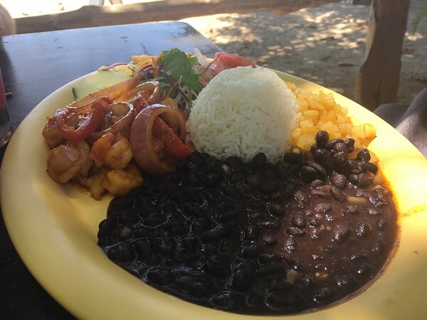 Small salad, beans, rice, shrimp and sauteed vegetables.