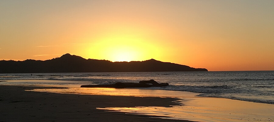 Sun sets over the ocean in Brasilito Costa Rica.