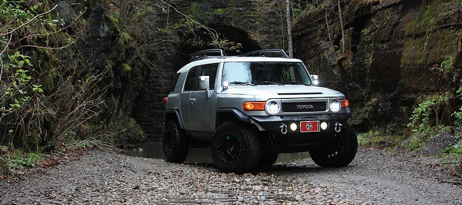 Toyota four wheel drive SUV on a dirt road in the jungle.