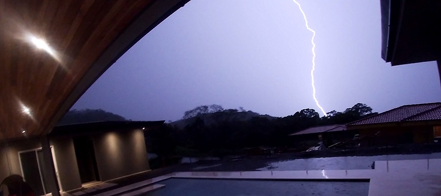 Lightning bolt strikes a few hundred yard away.