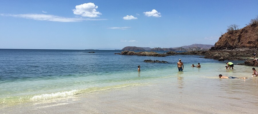 Swimmers enjoy the calm waters at the north end of Playa Conchal.