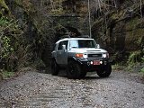 Toyota four wheel drive SUV on a dirt road in the jungle.